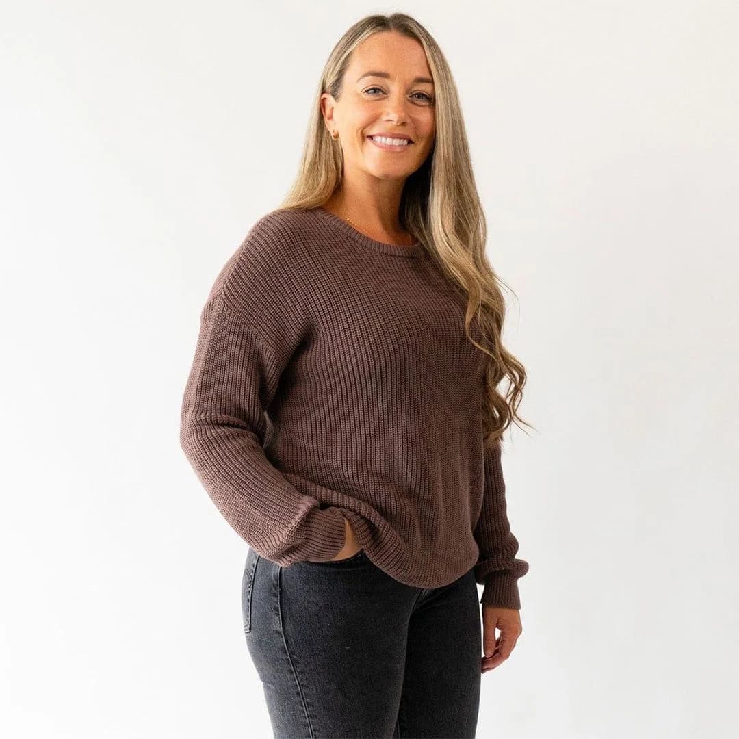 A nurse wearing a cozy custom sweater while attending to patients in a hospital environment.